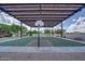 Shaded outdoor basketball court featuring modern equipment and picnic tables with desert views at 12733 S 177Th Ln, Goodyear, AZ 85338
