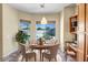 Cozy breakfast nook with a round table, four chairs, and a bright view of the backyard and pool at 12733 S 177Th Ln, Goodyear, AZ 85338