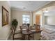 Formal dining room with a dark wood table set for six, a large window, and neutral décor at 12733 S 177Th Ln, Goodyear, AZ 85338