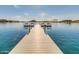 Picturesque view of a private wooden dock with benches on a serene lake surrounded by desert landscape at 12733 S 177Th Ln, Goodyear, AZ 85338