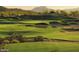 Lush green golf course with sand traps, desert vegetation, and mountain views in the background at 12733 S 177Th Ln, Goodyear, AZ 85338