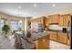Modern kitchen with a large island, granite countertops, stainless steel appliances, and ample cabinet space at 12733 S 177Th Ln, Goodyear, AZ 85338