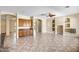 Open concept living area with tiled floors, built-in storage, cabinets, and neutral décor at 12733 S 177Th Ln, Goodyear, AZ 85338