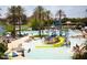 Fun-filled community waterpark with multiple pools, slides, palm trees, and lounge areas for residents to enjoy at 12733 S 177Th Ln, Goodyear, AZ 85338