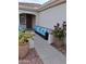 Inviting front porch with blue cushioned seating and decorative potted plants offering a cozy outdoor living space at 12945 W El Sueno Ct, Sun City West, AZ 85375