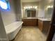 Bathroom featuring dual sinks, granite countertops, and a freestanding bathtub at 19322 E Calle De Flores --, Queen Creek, AZ 85142