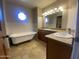 Bathroom featuring dual sinks, granite countertops, and a freestanding bathtub at 19322 E Calle De Flores --, Queen Creek, AZ 85142