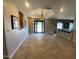 Spacious living room with tiled flooring, unique lighting, and large entryway at 19322 E Calle De Flores --, Queen Creek, AZ 85142