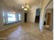 Spacious living room featuring tile floors, ample natural light from the large windows, and modern light fixtures at 19322 E Calle De Flores --, Queen Creek, AZ 85142