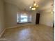 Bright living room boasting tile floors, a large bay window seat, and contemporary lighting fixtures at 19322 E Calle De Flores --, Queen Creek, AZ 85142