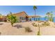 Desert landscaped backyard with patio area and a blue block wall providing privacy at 10322 E Excavation Ct, Gold Canyon, AZ 85118