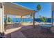 Enjoy outdoor living on this relaxing covered patio with desert landscaping and blue block wall at 10322 E Excavation Ct, Gold Canyon, AZ 85118