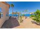 Desert backyard features mature landscaping, covered patio and a blue block wall at 10322 E Excavation Ct, Gold Canyon, AZ 85118