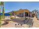 Expansive desert backyard with a covered patio, perfect for relaxing and enjoying the outdoors at 10322 E Excavation Ct, Gold Canyon, AZ 85118