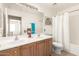 Bathroom featuring double sinks, wood cabinets, a toilet, and a shower with bathtub combination at 10322 E Excavation Ct, Gold Canyon, AZ 85118