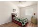Cozy bedroom with wood flooring, a quilt-covered bed, and a side table at 10322 E Excavation Ct, Gold Canyon, AZ 85118