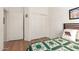 Bedroom with laminate floors, a quilt-covered bed, and closet at 10322 E Excavation Ct, Gold Canyon, AZ 85118