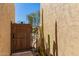 Inviting gated courtyard with desert landscaping and mature cacti accents at 10322 E Excavation Ct, Gold Canyon, AZ 85118