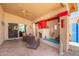Inviting covered patio with fireplace, ceiling fan and comfortable seating, perfect for outdoor relaxation at 10322 E Excavation Ct, Gold Canyon, AZ 85118