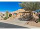 Single-story home featuring desert landscaping and a two-car garage at 10322 E Excavation Ct, Gold Canyon, AZ 85118