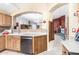 Open kitchen with wooden cabinets, stainless steel appliances, and a view into the living room at 10322 E Excavation Ct, Gold Canyon, AZ 85118