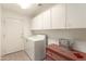Practical laundry room with ample storage cabinets and space for laundry appliances at 10322 E Excavation Ct, Gold Canyon, AZ 85118