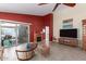 Inviting living room with a fireplace, entertainment center, and access to the backyard patio at 10322 E Excavation Ct, Gold Canyon, AZ 85118