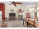 Open-concept living room with vaulted ceilings, tile floors, and a decorative ceiling fan at 10322 E Excavation Ct, Gold Canyon, AZ 85118