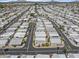 Expansive aerial view of a well-maintained mobile home community with palm tree lined streets at 111 S Greenfield Rd # 313, Mesa, AZ 85206