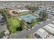 Aerial view of community amenities including swimming pool, tennis courts, shuffleboard court and clubhouse at 111 S Greenfield Rd # 313, Mesa, AZ 85206