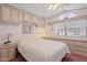 Inviting bedroom features built-in cabinets and a large window overlooking the front of the property at 111 S Greenfield Rd # 313, Mesa, AZ 85206