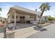 Charming home featuring a covered carport, desert landscaping, and a welcoming facade at 111 S Greenfield Rd # 313, Mesa, AZ 85206
