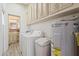 Well-equipped laundry area with washer, dryer, water heater, and ample storage space at 111 S Greenfield Rd # 313, Mesa, AZ 85206