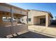 A charming backyard with a covered patio and an extended concrete patio at 11835 W Windsor Ave, Avondale, AZ 85392