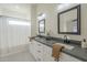 Bathroom features a dual sink vanity with a dark countertop and modern fixtures at 11835 W Windsor Ave, Avondale, AZ 85392