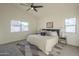 Comfortable bedroom showcases a ceiling fan and large windows that bring in natural light at 11835 W Windsor Ave, Avondale, AZ 85392