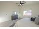 Bright secondary bedroom includes a ceiling fan and a large window that brings in natural light at 11835 W Windsor Ave, Avondale, AZ 85392