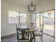 Bright dining area with a modern chandelier, wood table, and access to the outdoor patio at 11835 W Windsor Ave, Avondale, AZ 85392