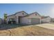 Inviting single-story home with well-kept landscaping and a two-car garage at 11835 W Windsor Ave, Avondale, AZ 85392