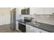 Kitchen features stainless steel appliances, white cabinets, gray countertops, and tile backsplash at 11835 W Windsor Ave, Avondale, AZ 85392