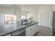 Bright kitchen with stainless appliances, gray countertops, and an island perfect for entertaining at 11835 W Windsor Ave, Avondale, AZ 85392