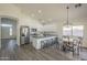Spacious kitchen with stainless steel appliances, white cabinets, gray countertops, and a breakfast bar with seating at 11835 W Windsor Ave, Avondale, AZ 85392