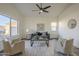 Bright living room featuring wood flooring, contemporary decor, and sunlit windows at 11835 W Windsor Ave, Avondale, AZ 85392