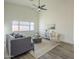 Living room with vaulted ceilings, a comfortable gray couch, and plenty of natural light at 11835 W Windsor Ave, Avondale, AZ 85392