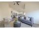 Bright living room features an open floor plan that seamlessly connects to the modern white kitchen at 11835 W Windsor Ave, Avondale, AZ 85392