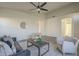 Well-lit living room with a modern ceiling fan, neutral decor, and an open floor plan at 11835 W Windsor Ave, Avondale, AZ 85392
