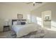 Bright main bedroom is adjacent to the main bathroom and includes a ceiling fan and large windows at 11835 W Windsor Ave, Avondale, AZ 85392