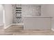 An open bar area featuring wood-look flooring, decorative black and white wallpaper, and light gray countertops at 12941 W Flower St, Avondale, AZ 85392