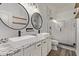 Modern bathroom featuring dual vessel sinks, granite countertops, and a walk-in shower at 12941 W Flower St, Avondale, AZ 85392