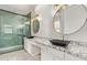 Beautiful bathroom with dual sinks, granite countertops, and a modern tiled walk-in shower at 12941 W Flower St, Avondale, AZ 85392